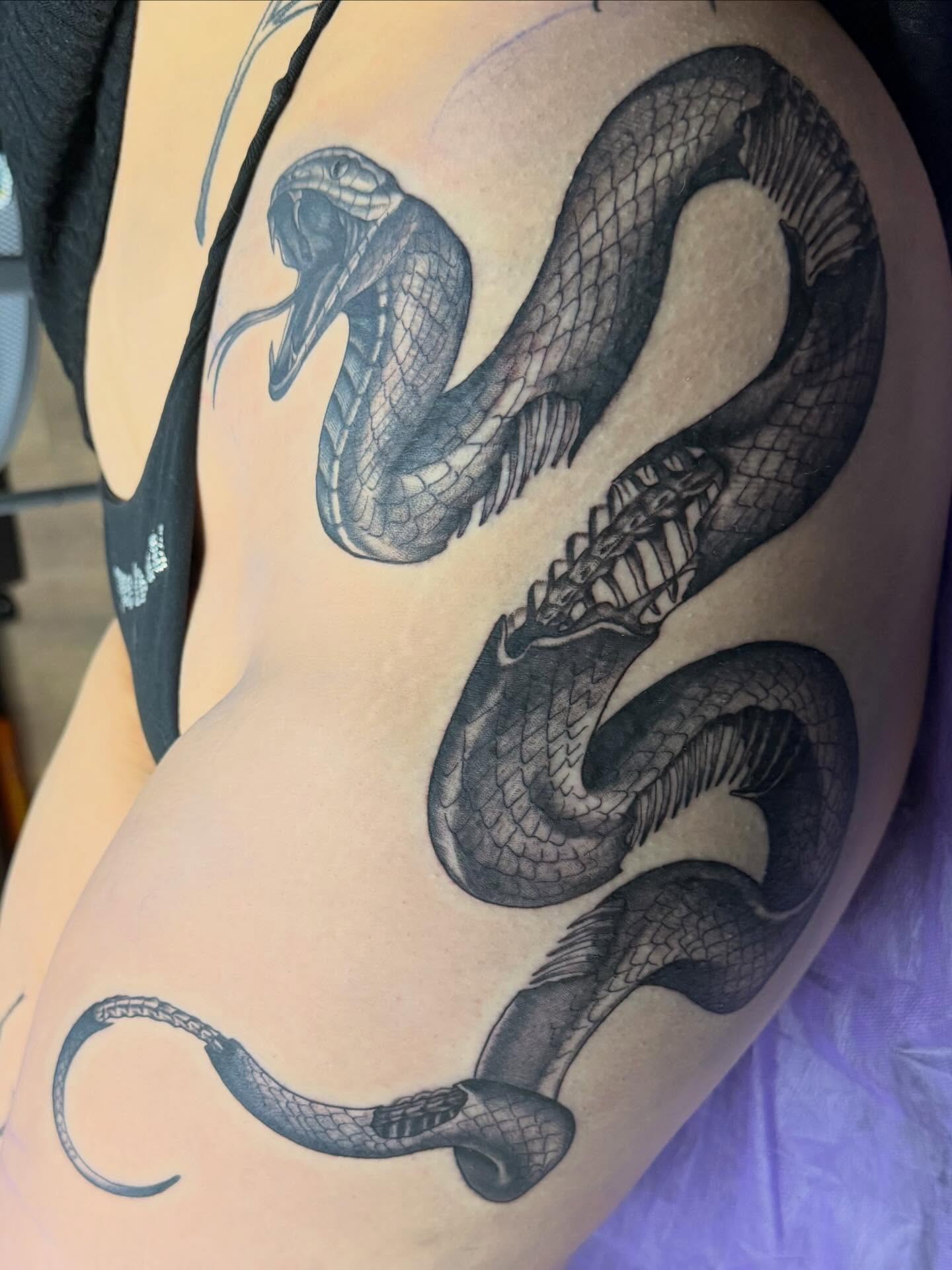 Snake black and grey tattoo on the thigh by Tina Gregg, North Ridgeville, Ohio