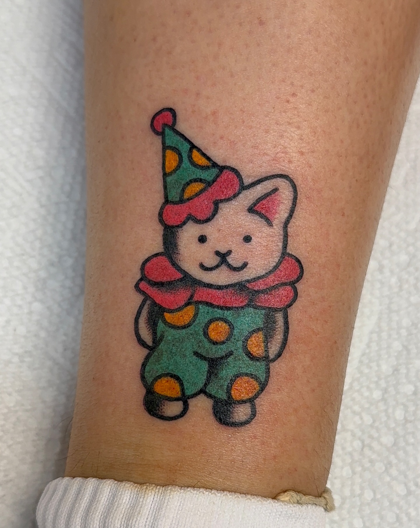 Clown cat new school tattoo on the forearm by VAY