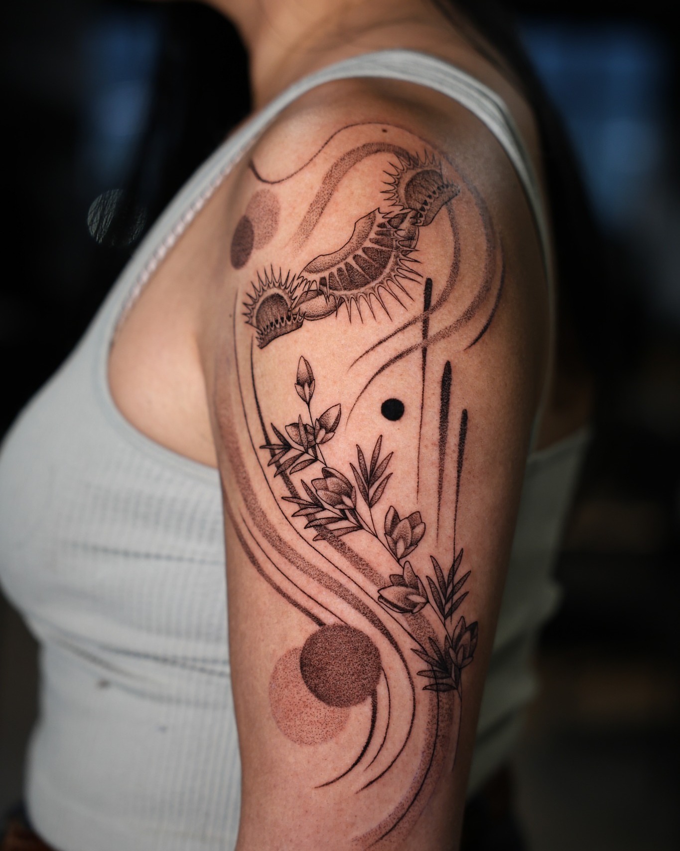 Abstract floral and celestial design dotwork tattoo on the upper arm by Hannah Burnside, Charlotte, North Carolina