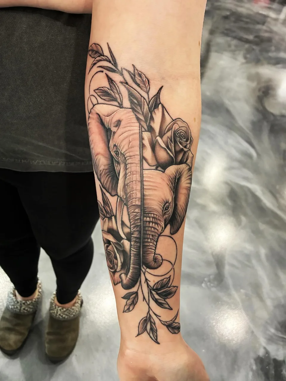 Elephant and roses realism tattoo on the forearm by Adam Silfies