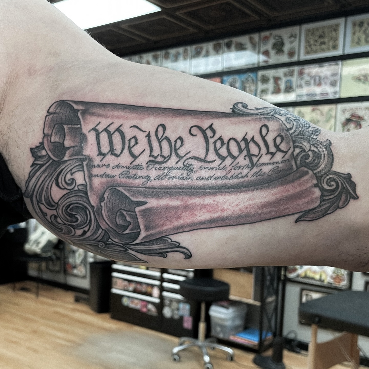 We the People black and grey tattoo on the forearm by JoDee Yates