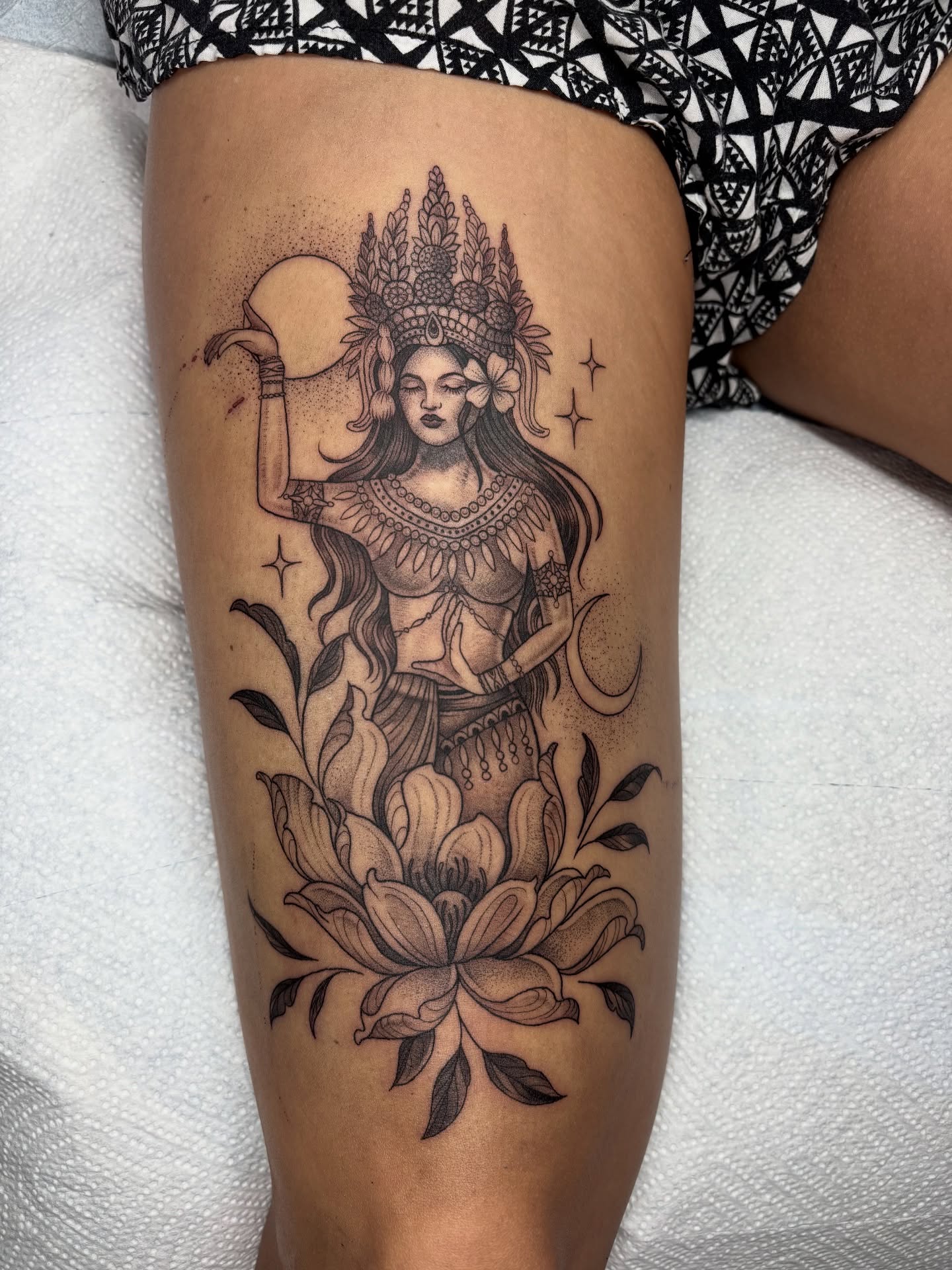 Goddess with lotus dotwork tattoo on the thigh by Kinsey Miller