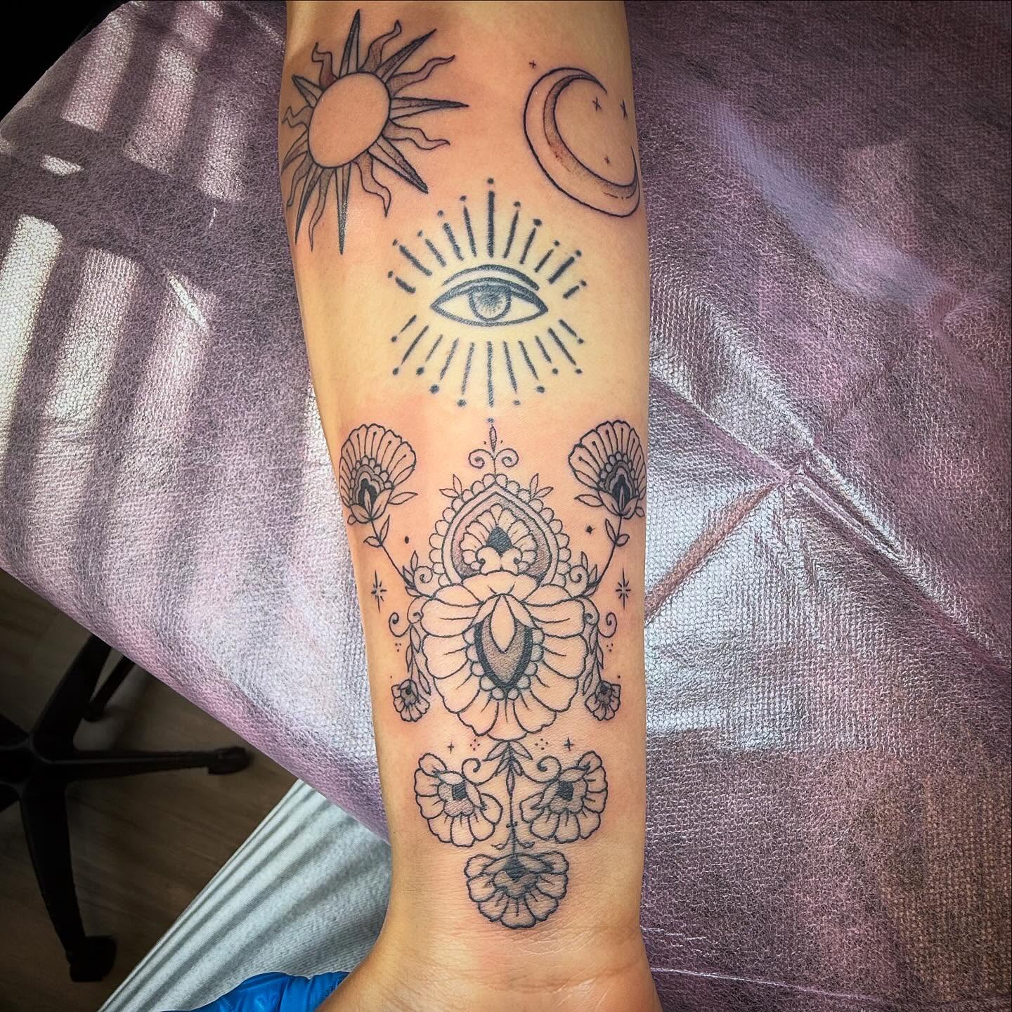 Sun, moon, eye, floral mandala dotwork tattoo on the forearm by Taytum Marsing, Salt Lake City, Utah