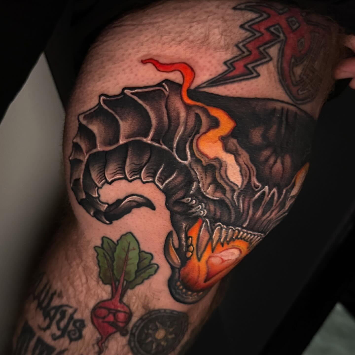 Beetroot and dragon American traditional tattoo on the thigh by Katie Rojas