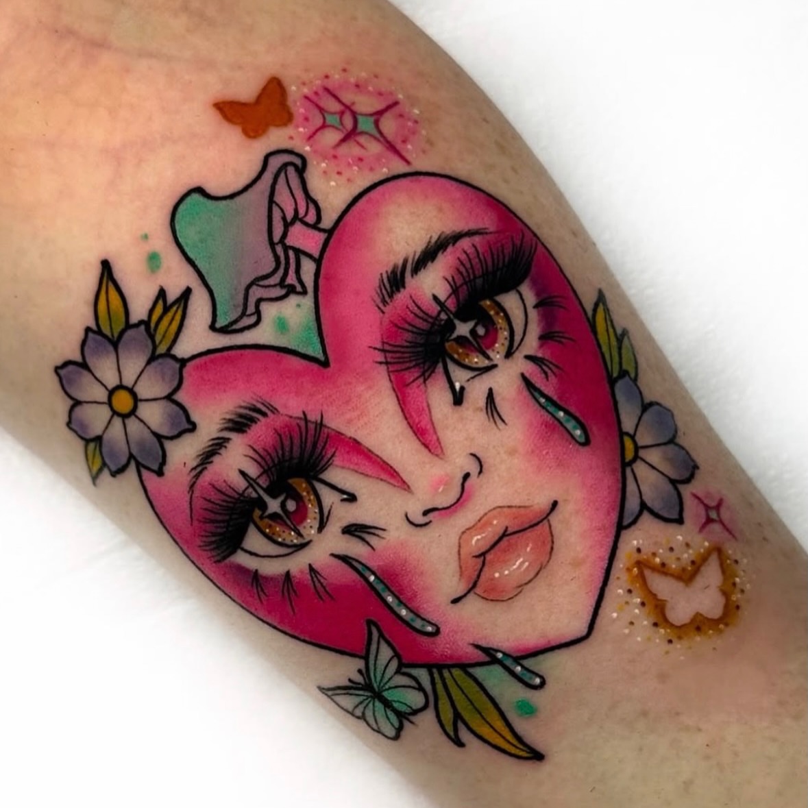 Heart with crying eyes American traditional tattoo on the forearm by 𝐊𝐚𝐫𝐚 𝐍𝐨𝐞𝐥, Dallas, Texas