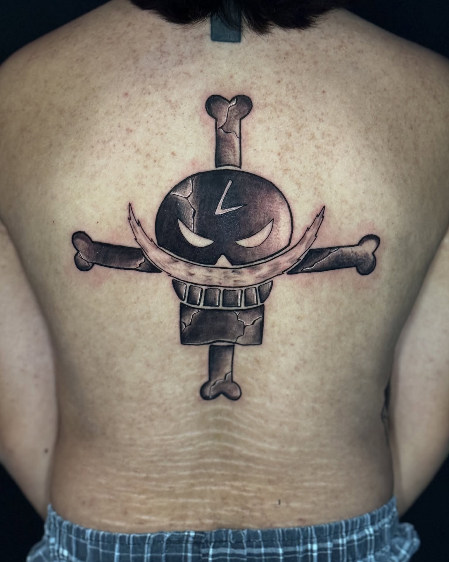 Skull pirate black and grey tattoo on the back by Mariyah Rhae Lewis
