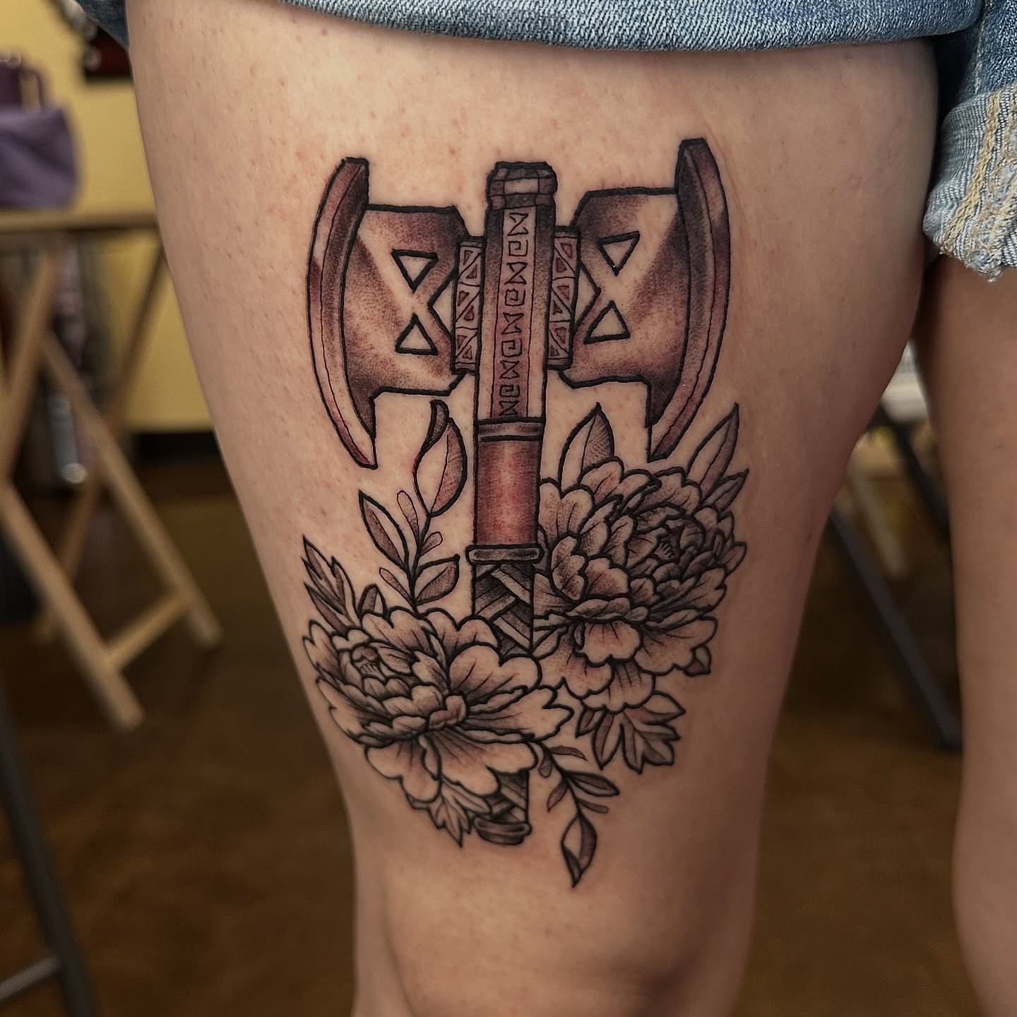 Axes and flowers geometric tattoo on the thigh by Nick Bones, Las Vegas, Nevada