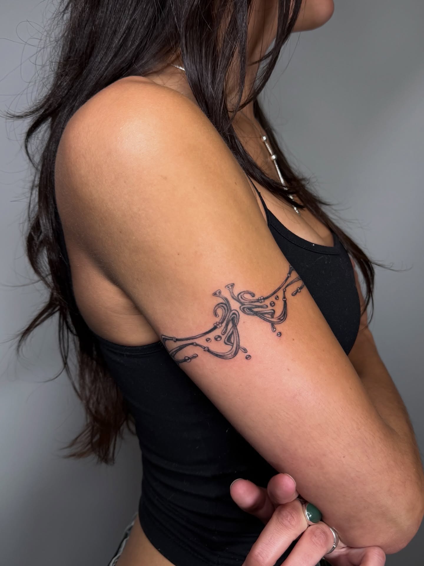 Abstract fluid design black and grey tattoo on the forearm by Lauren ๐