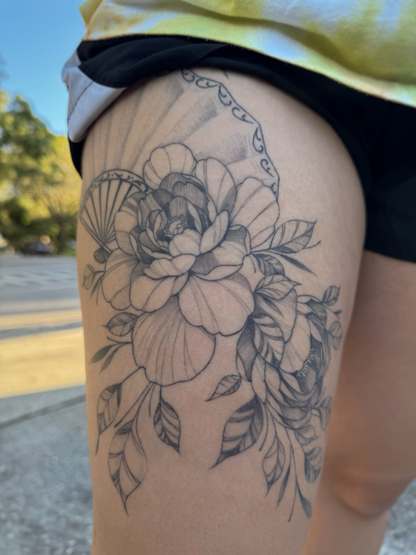 Flower black and grey tattoo on the thigh by Gianna Rodriguez
