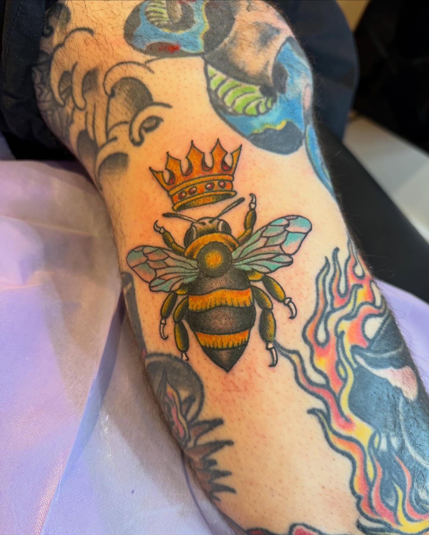 Bee with crown American traditional tattoo on the forearm by Mike Kepper