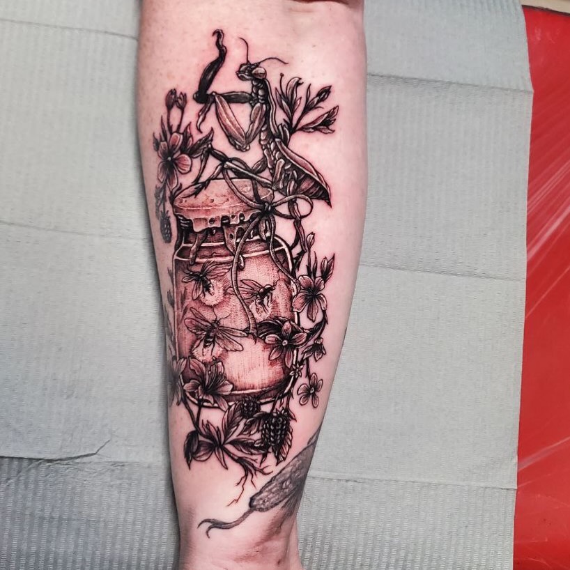 Insect and flowers realism tattoo on the forearm by Matthew Ray, Harrisburg, North Carolina
