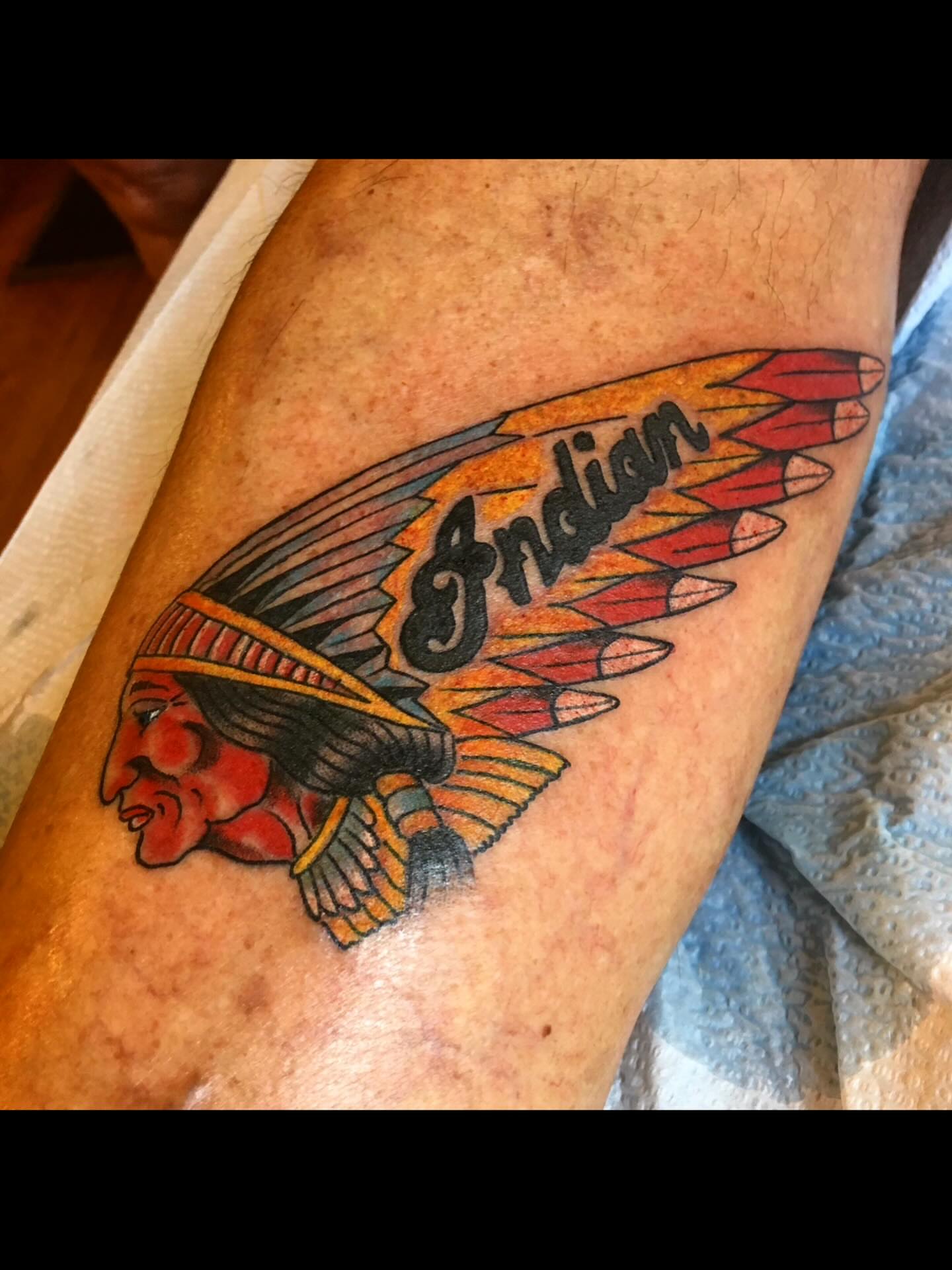 Indian headdress American traditional tattoo on the forearm by Mike Kepper