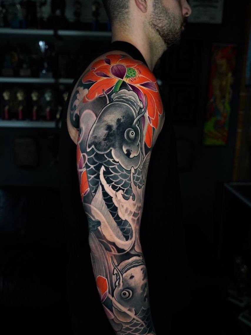 Koi fish and lotus flower japanese irezumi tattoo on the upper arm by Grego Hernandez, Miami, Florida
