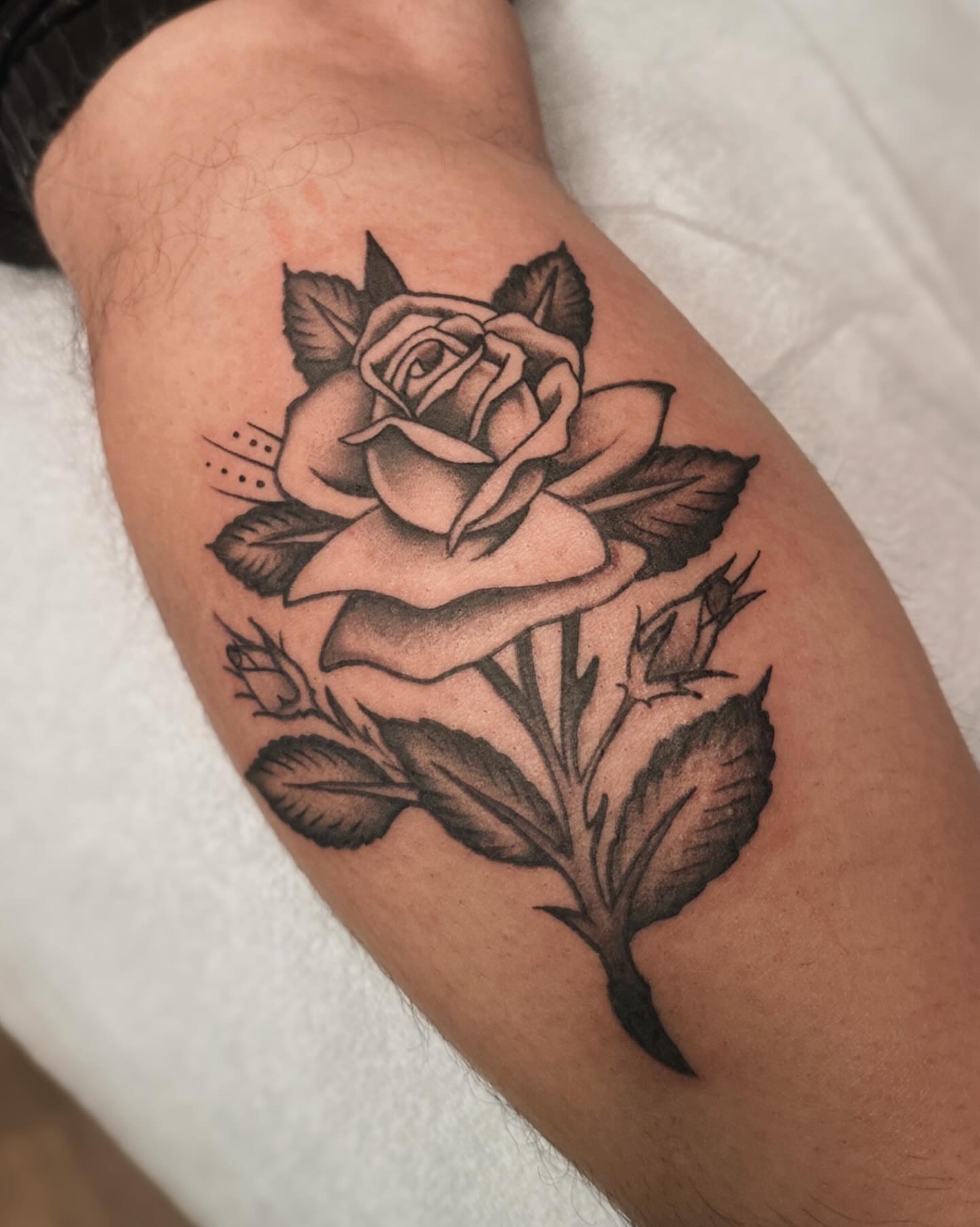 Rose black and grey tattoo on the forearm by Craig Ryans