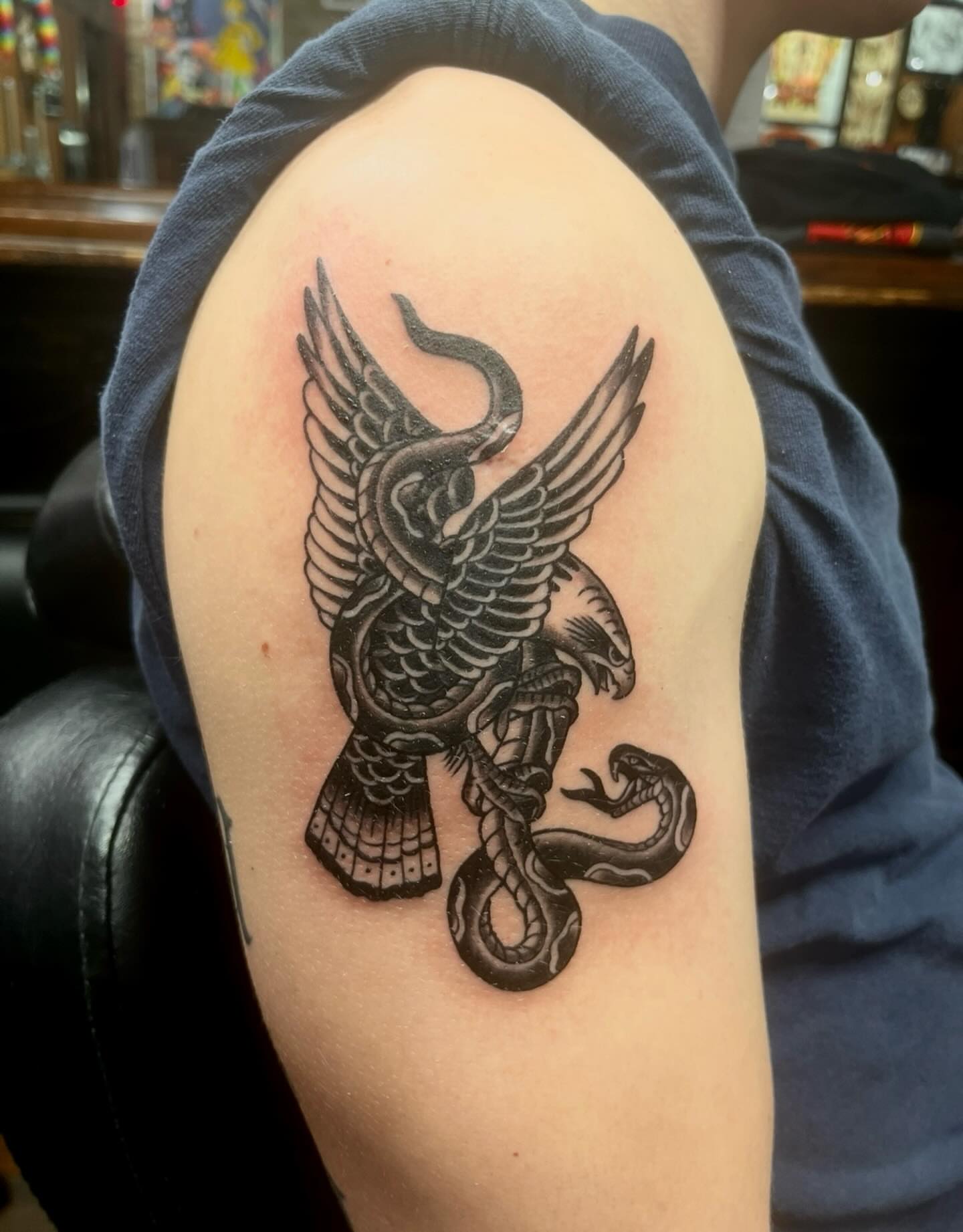 Eagle and snake black and grey tattoo on the shoulder by Kenny Buck