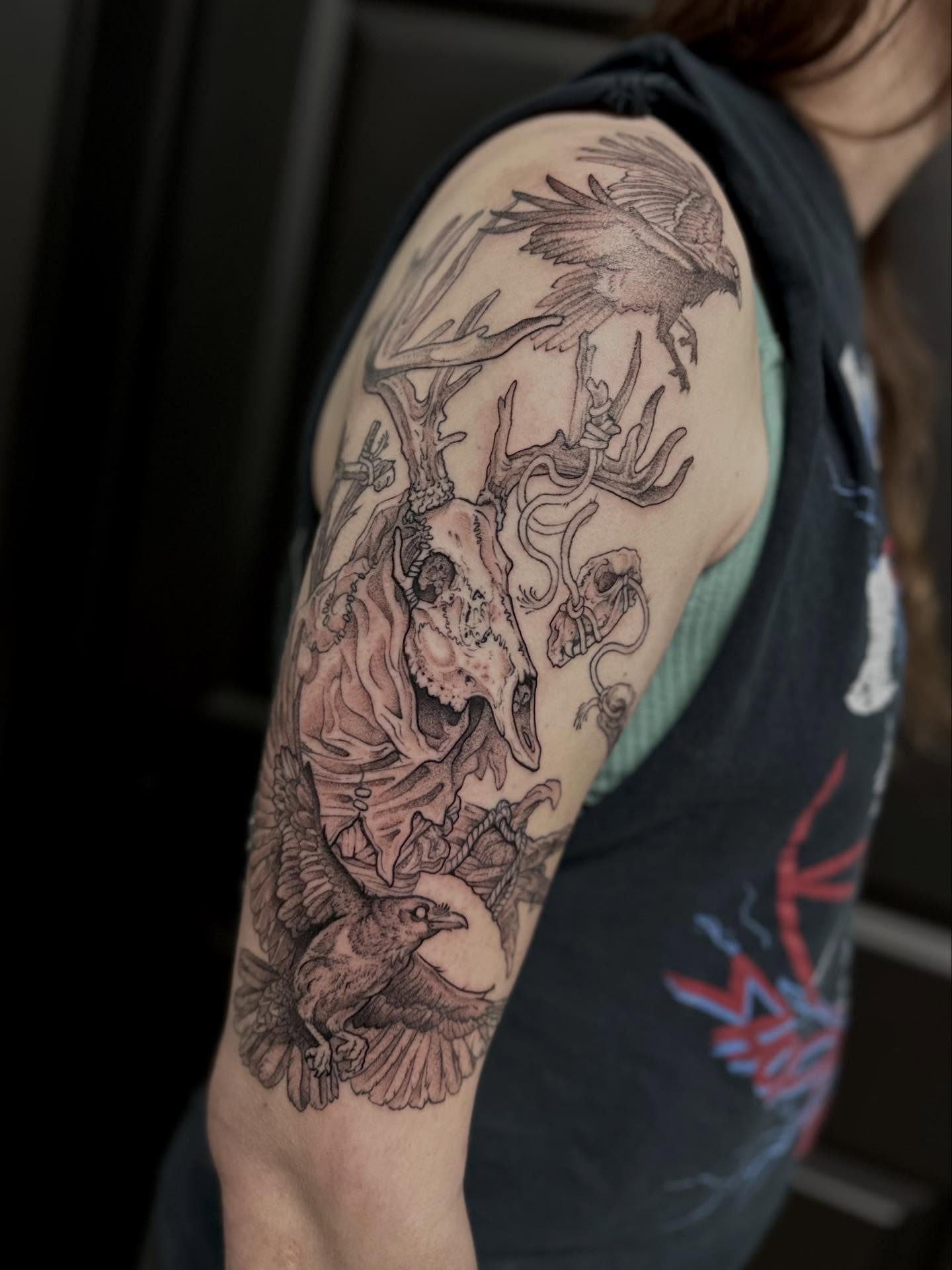 Deer skull and crows realism tattoo on the upper arm by Ciera High l Tattoo Artist