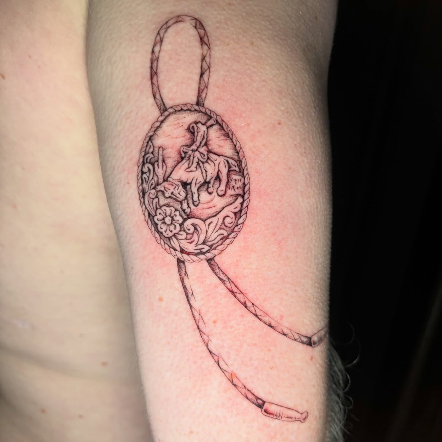 Medallion with horse and rider black and grey tattoo on the forearm by Jojo Rose ✨ Denver Tattoo Artist