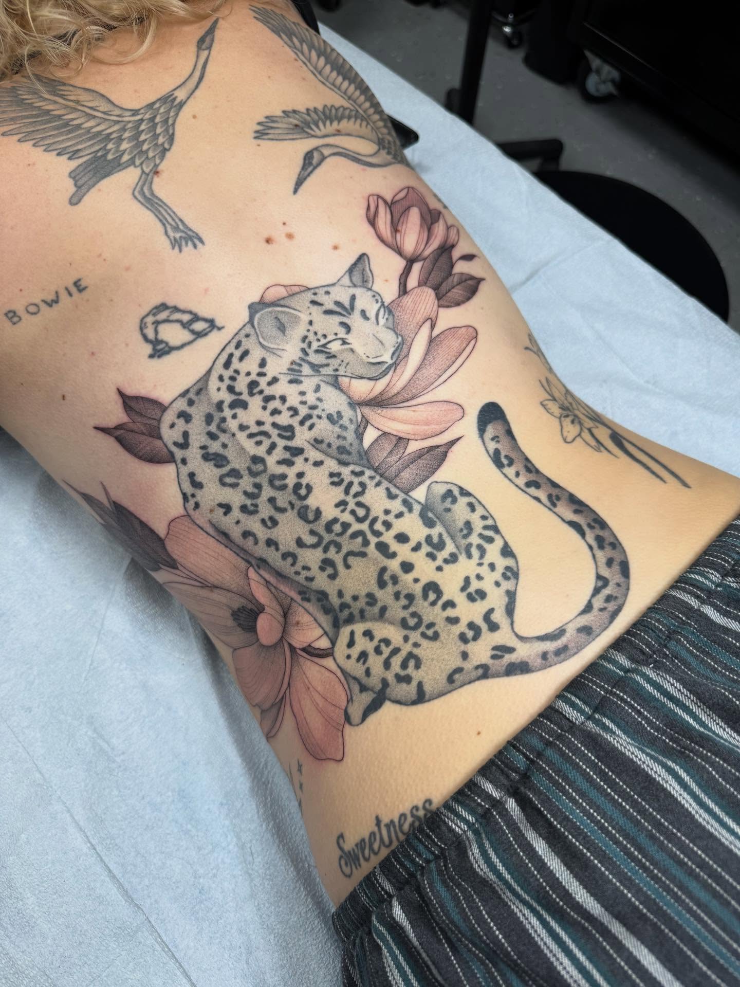 Leopard and lotus realism tattoo on the thigh by Maddie Jo DeYoung