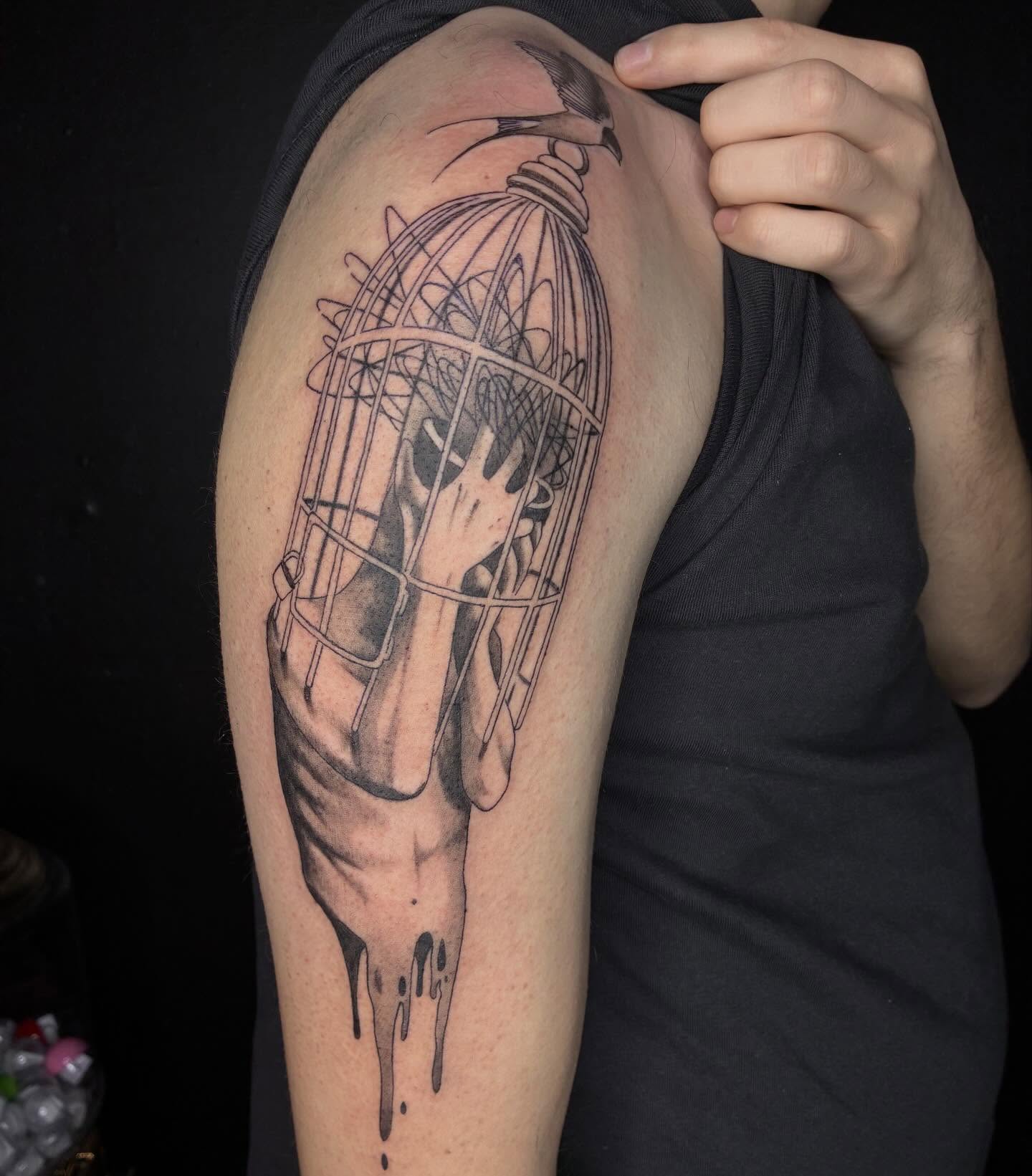 Bird cage realism tattoo on the upper arm by Kat π