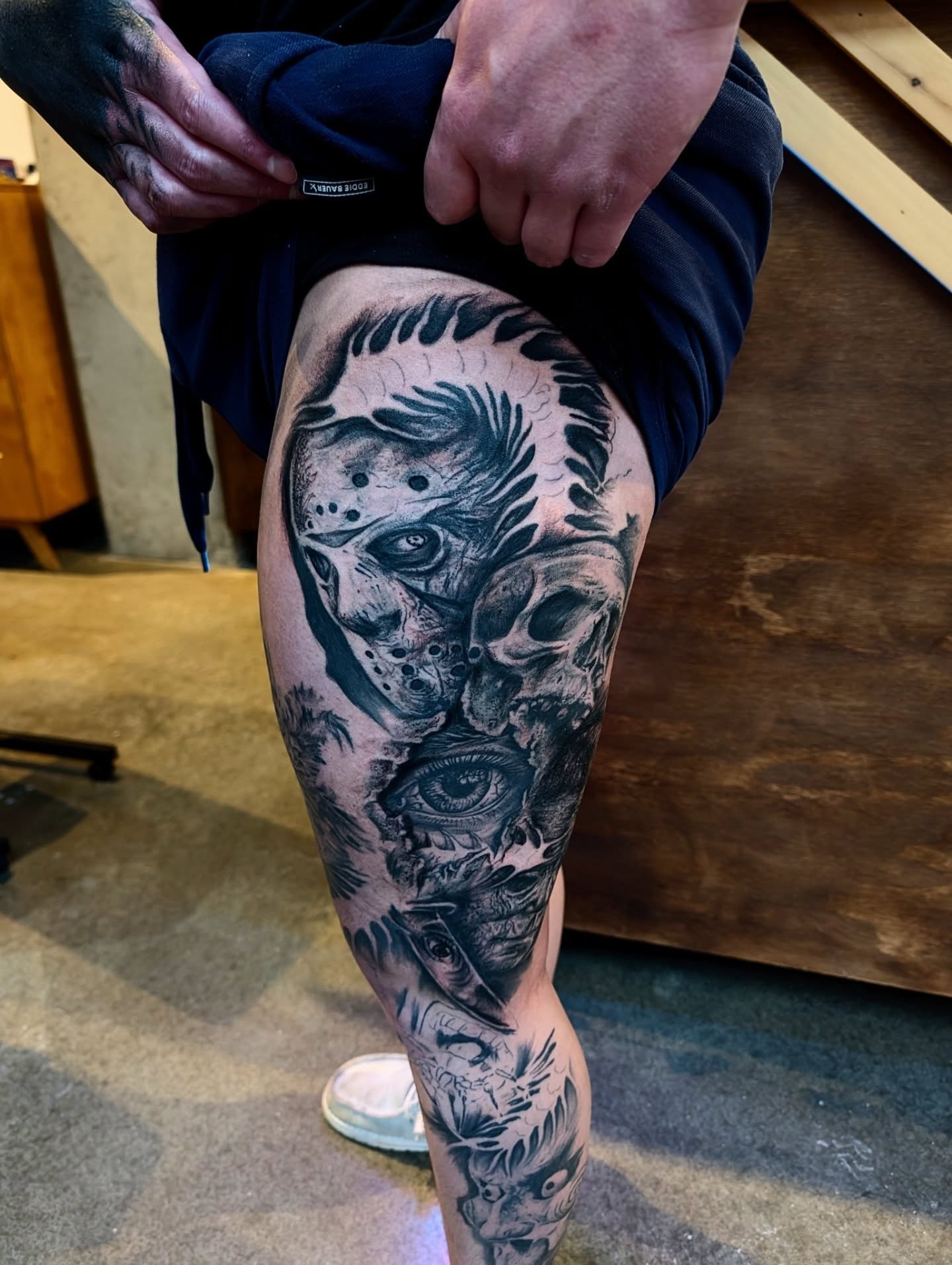 Horror mask and skull realism tattoo on the thigh by Drew King