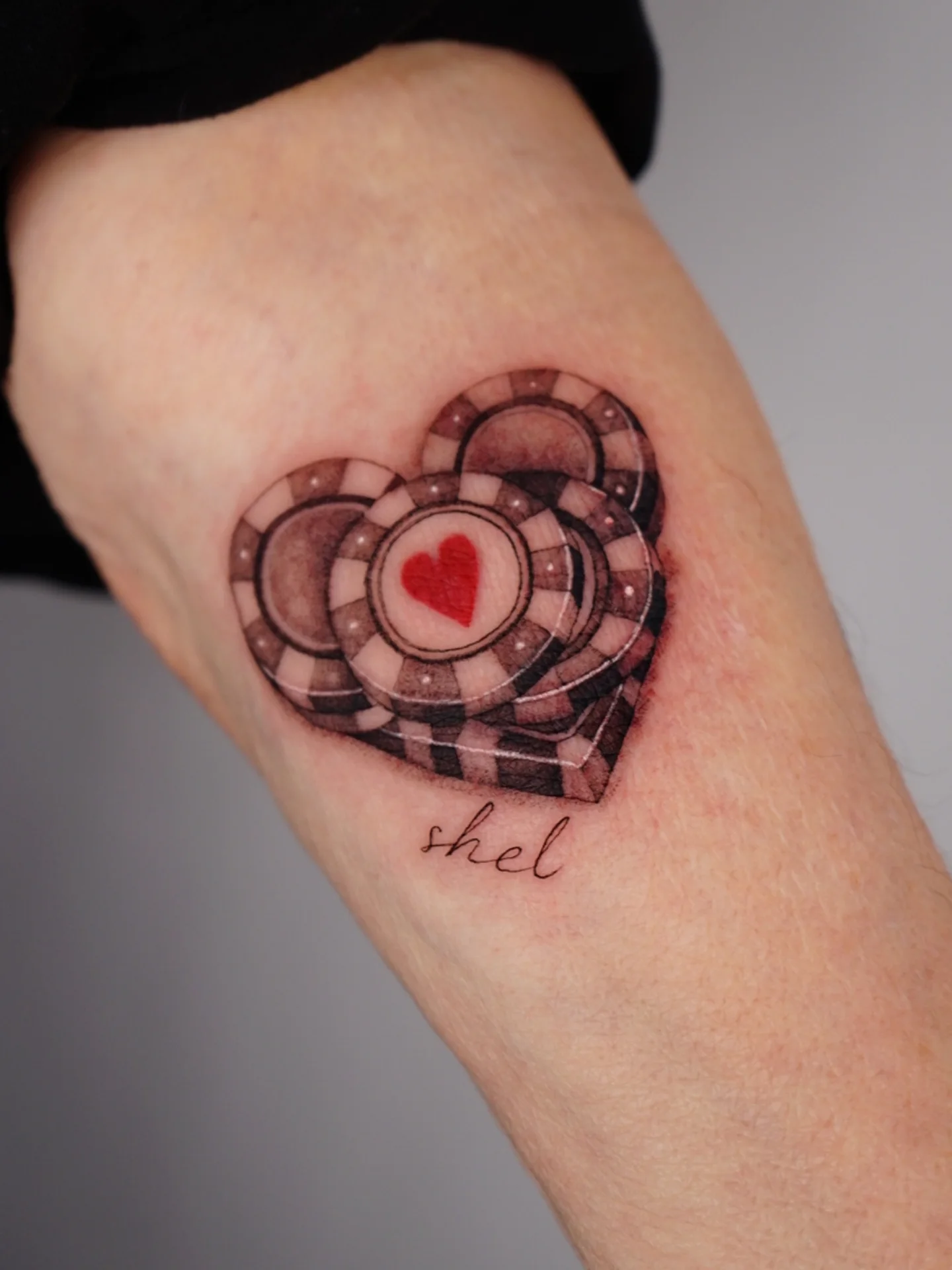 Heart with poker chips geometric tattoo on the forearm by Vii