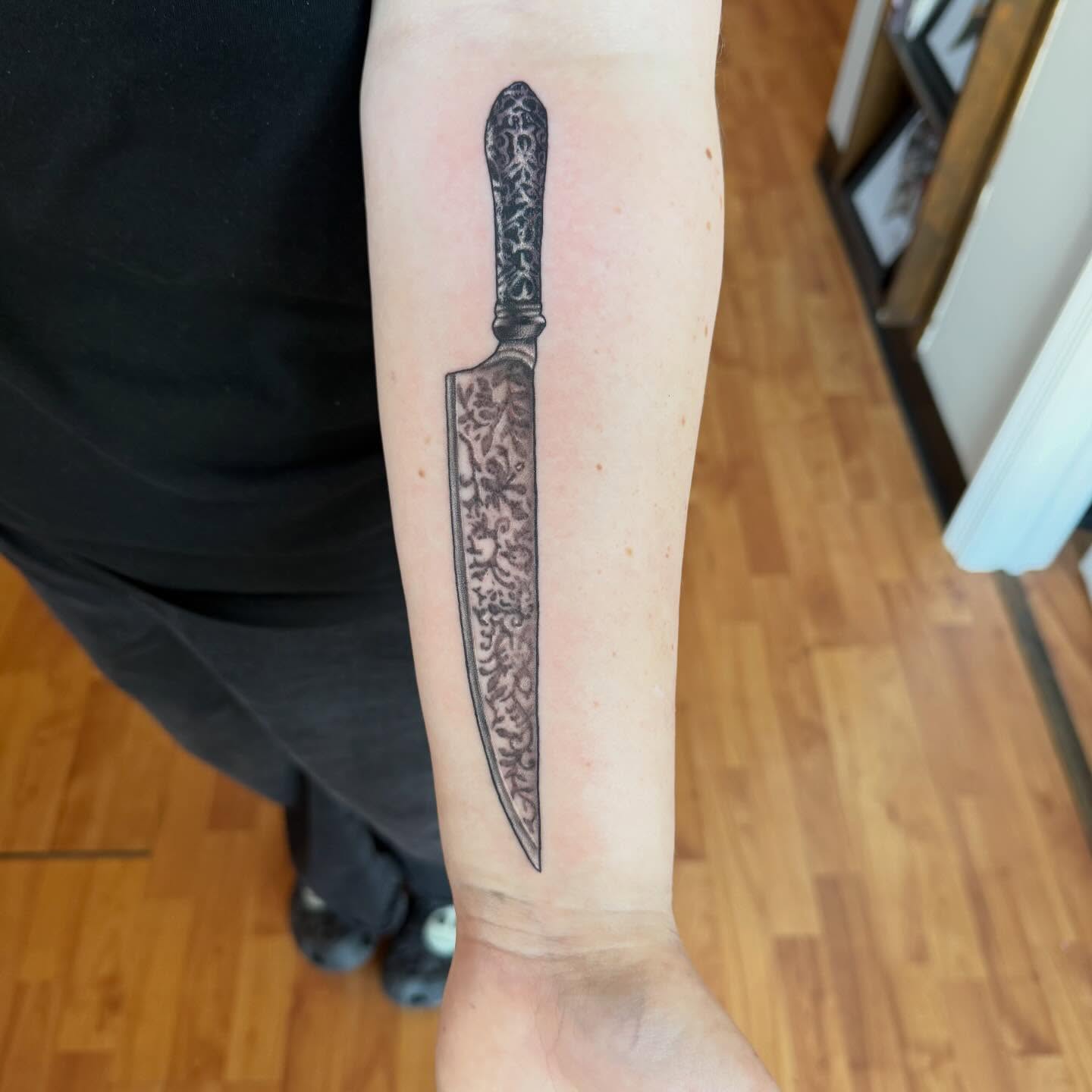 Knife black and grey tattoo on the forearm by Matt Hattaway