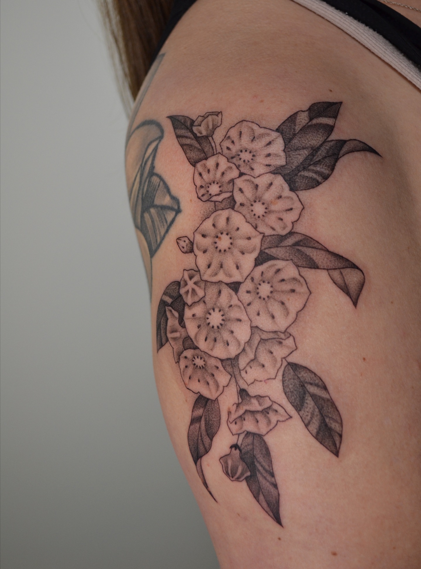 Flower bouquet black and grey tattoo on the shoulder by Vanessa Acosta