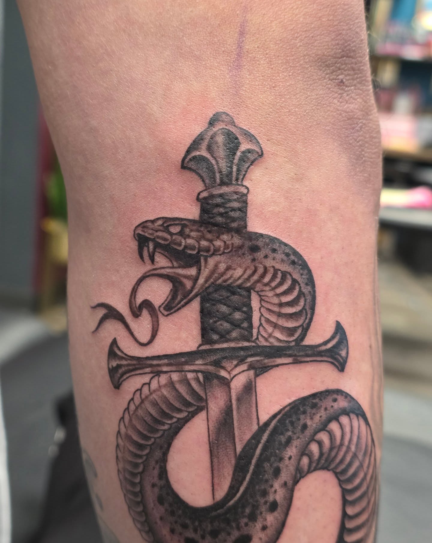 Snake and dagger black and grey tattoo on the forearm by Martin Colonna