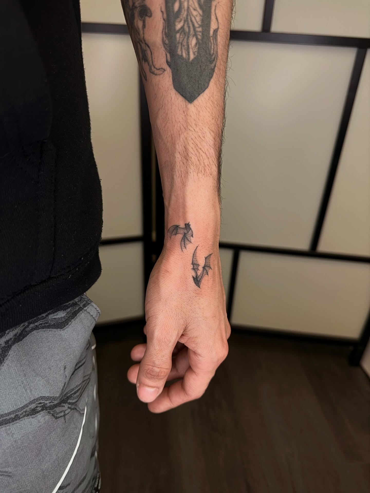 Bat black and grey tattoo on the forearm by Dabbo🩸
