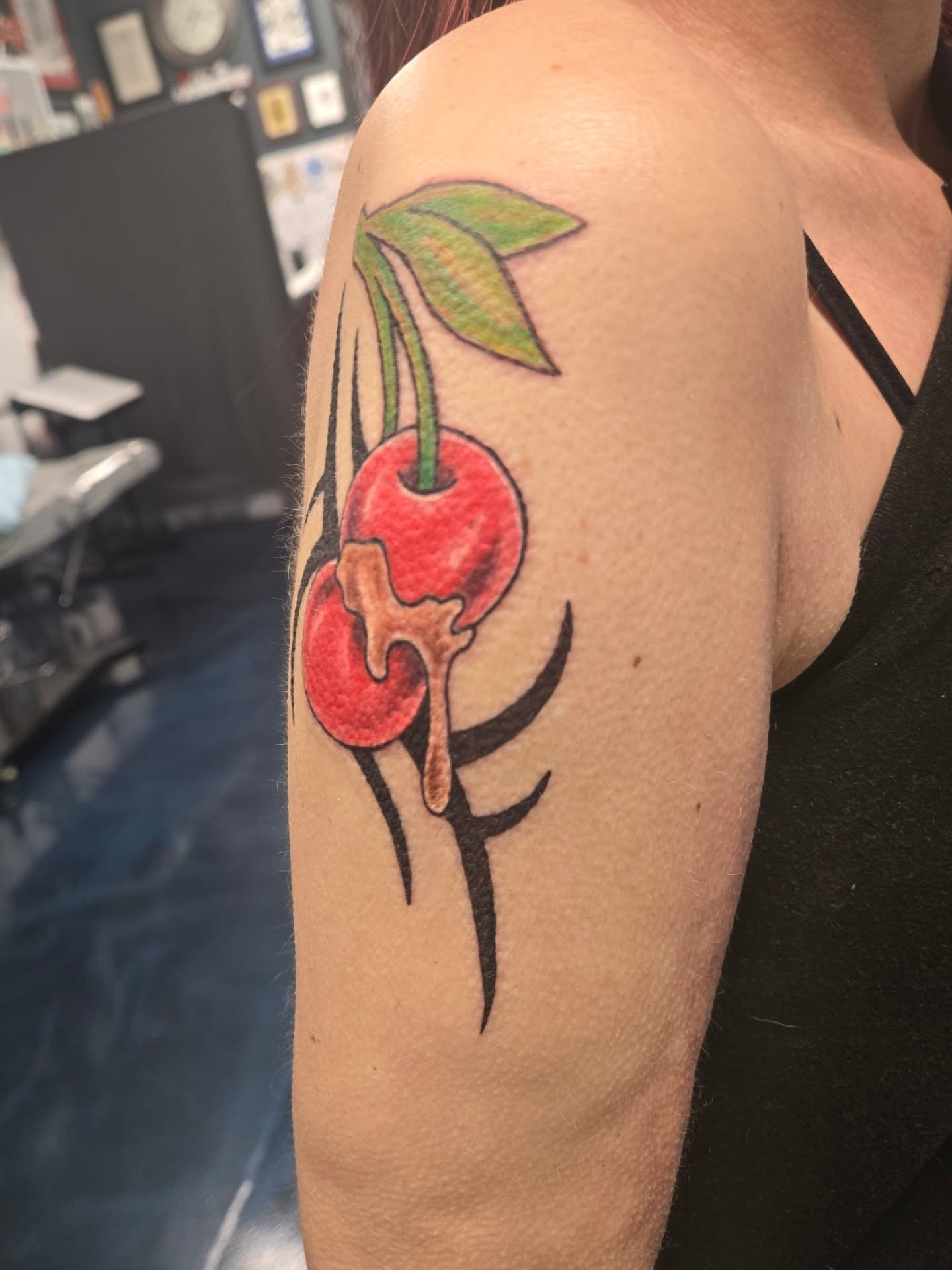 Cherry American traditional tattoo on the upper arm by Matt Page