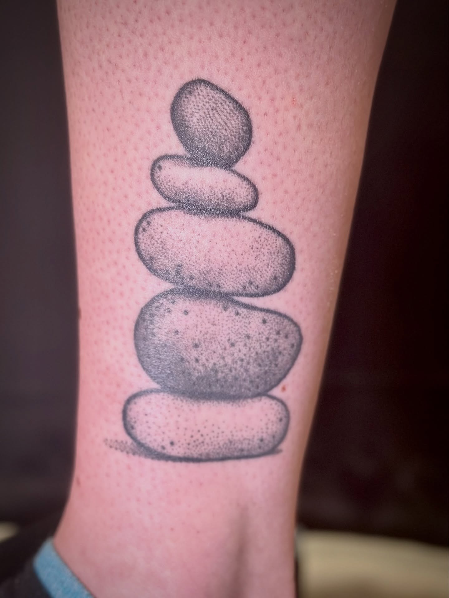 Stacked stones dotwork tattoo on the forearm by Maddie Morrill