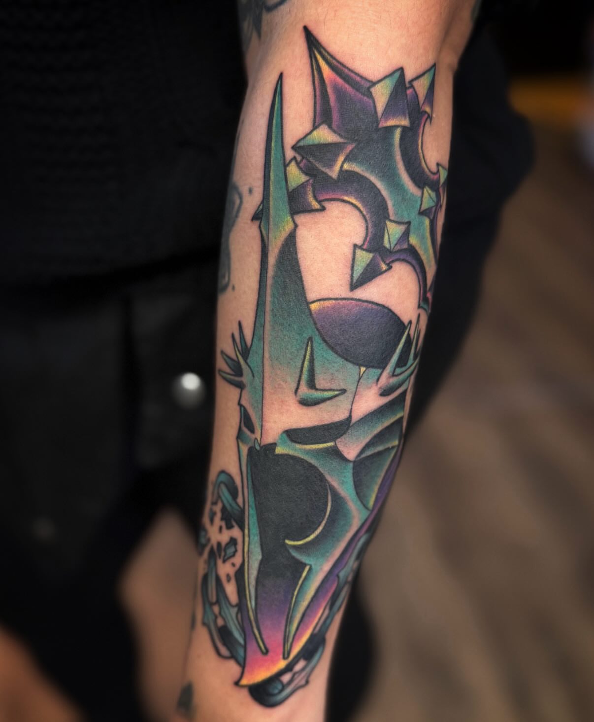 Geometric dragon geometric tattoo on the forearm by Chase Martines