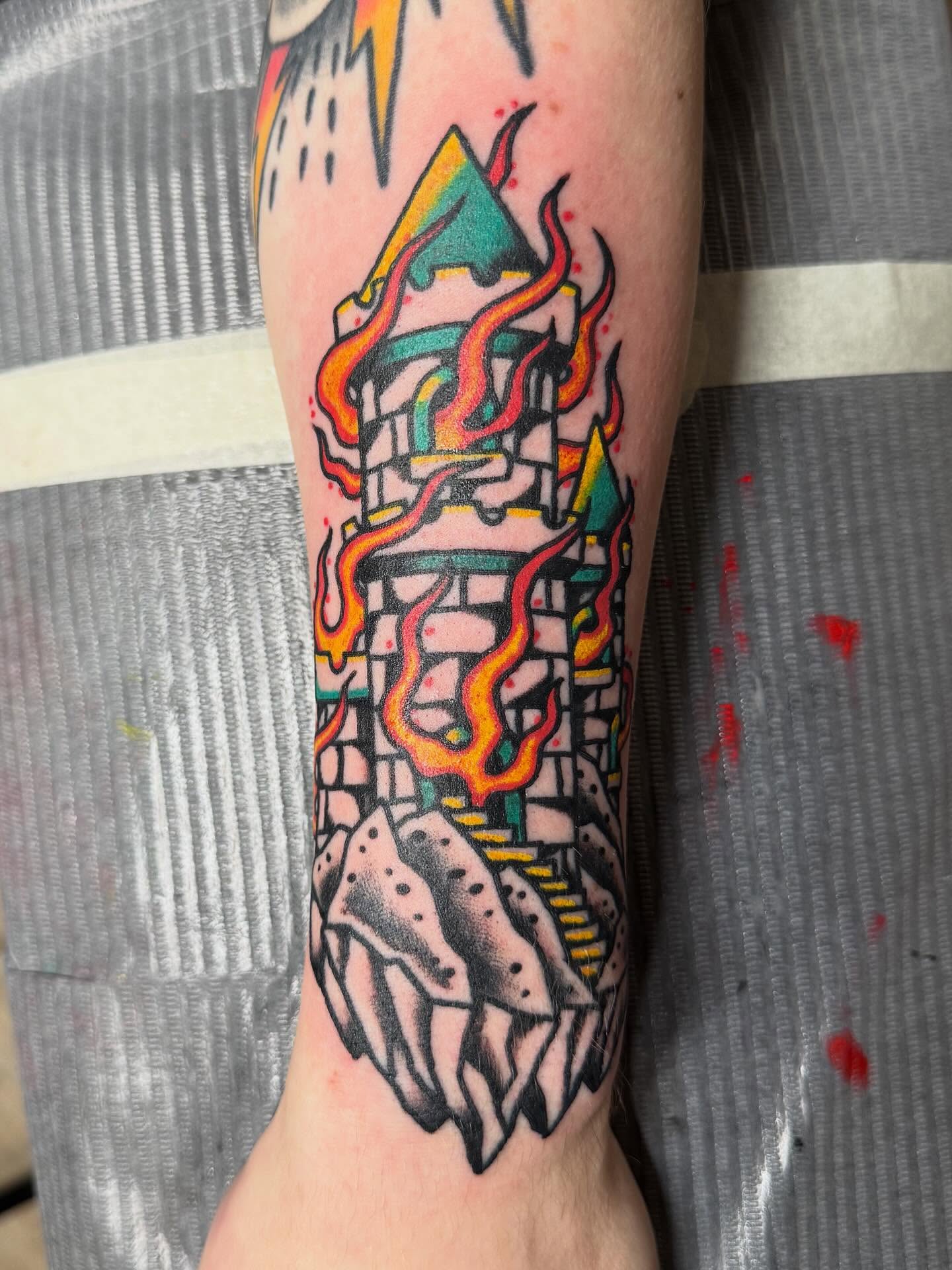 Fire and structure American traditional tattoo on the forearm by Bill Crawford, Plymouth, Michigan