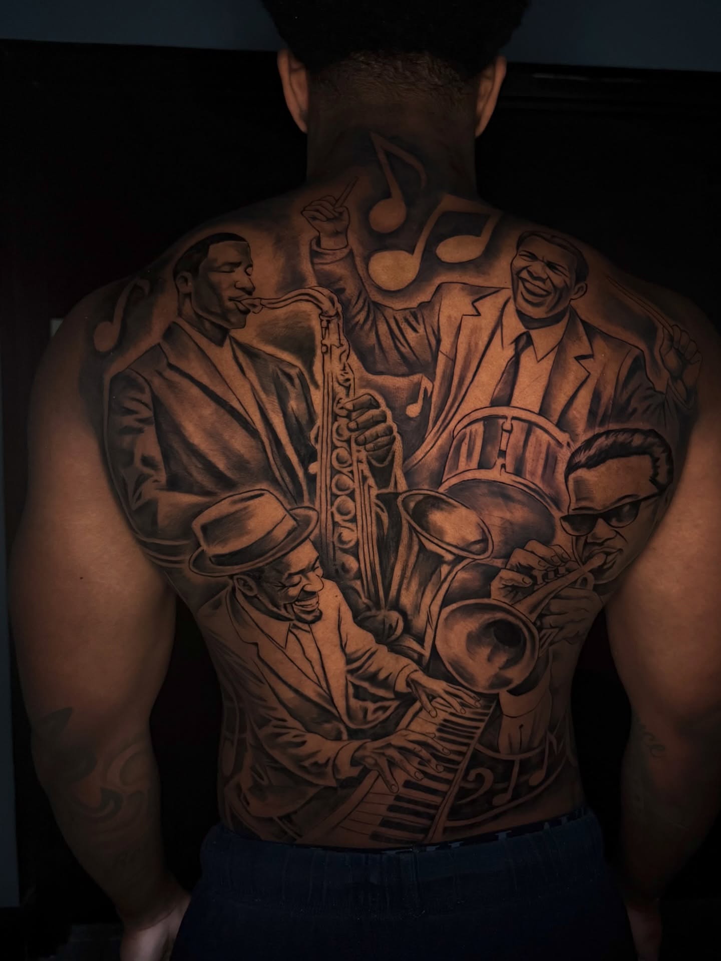 Jazz musicians realism tattoo on the back by Dontavious Davis