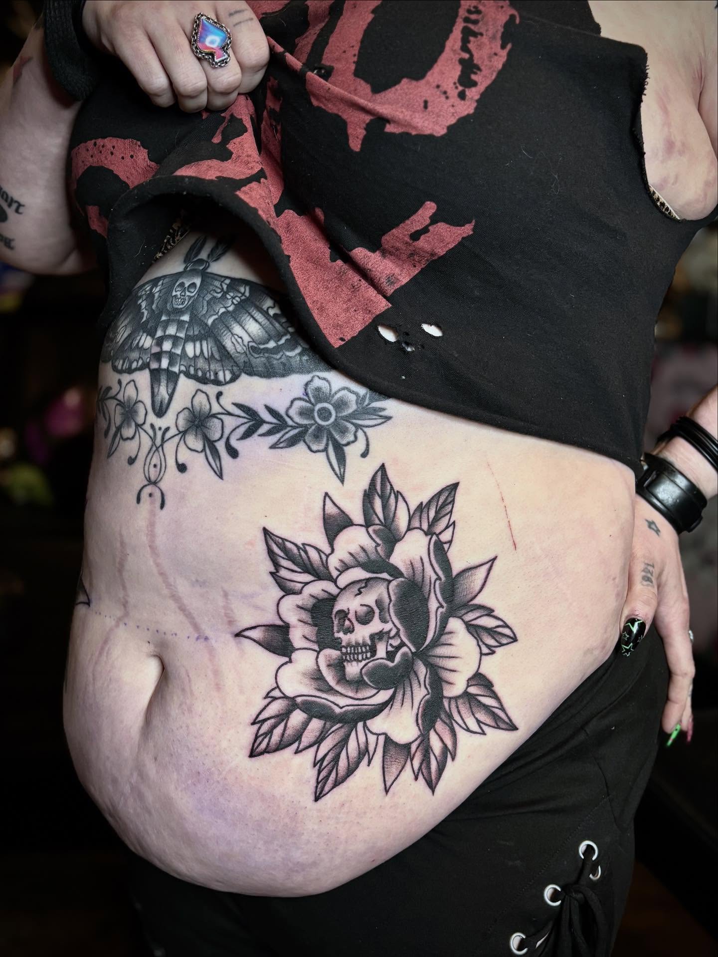 Flower with skull American traditional tattoo on the thigh by Mim