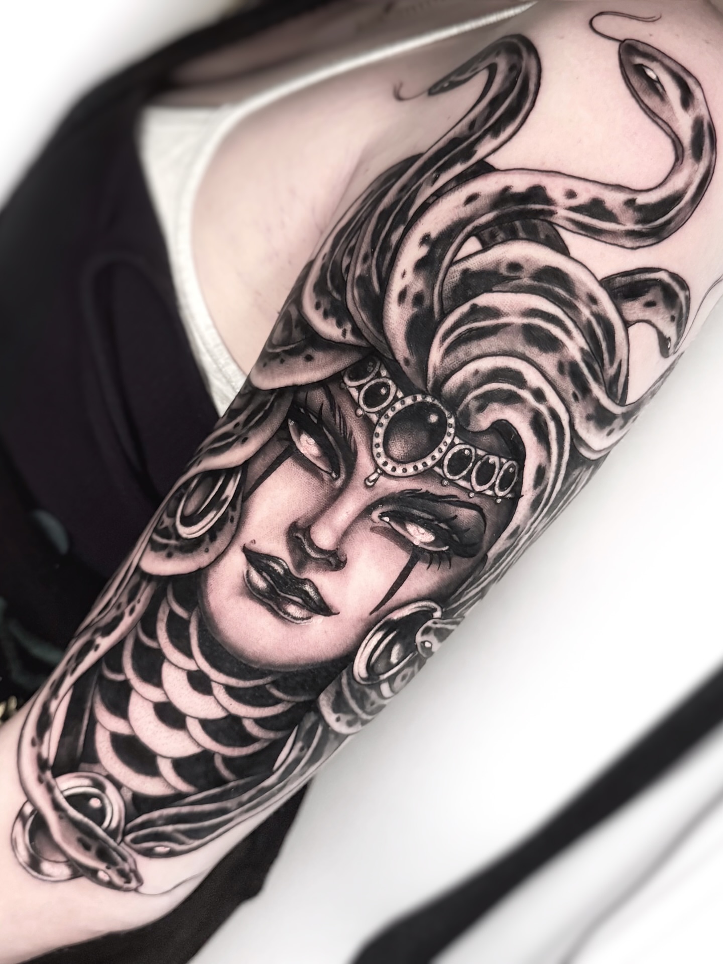 Medusa realism tattoo on the forearm by Tommy Sisneros