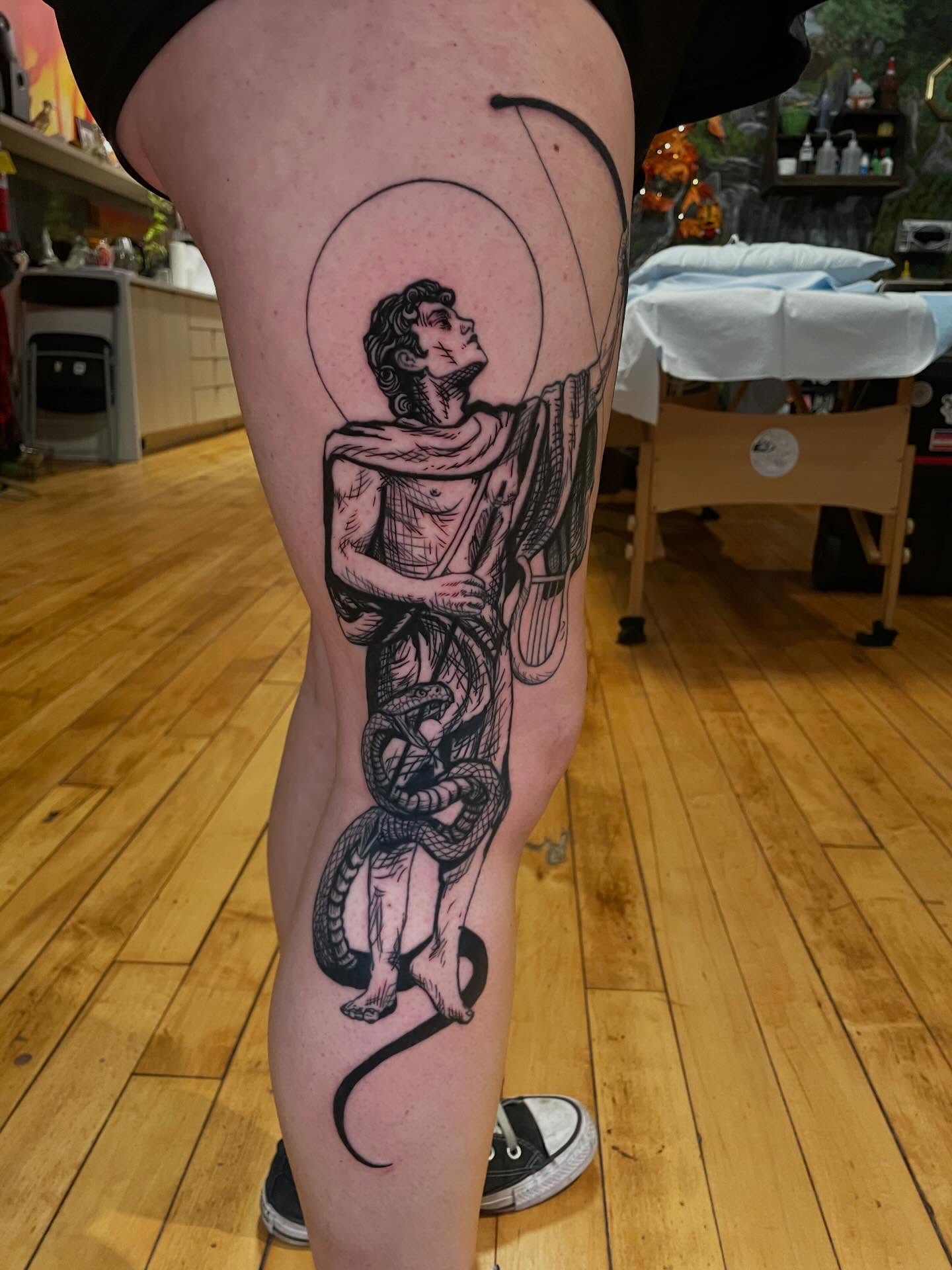 Man with snake black and grey tattoo on the thigh by Lake Stephens, Richmond, Virginia