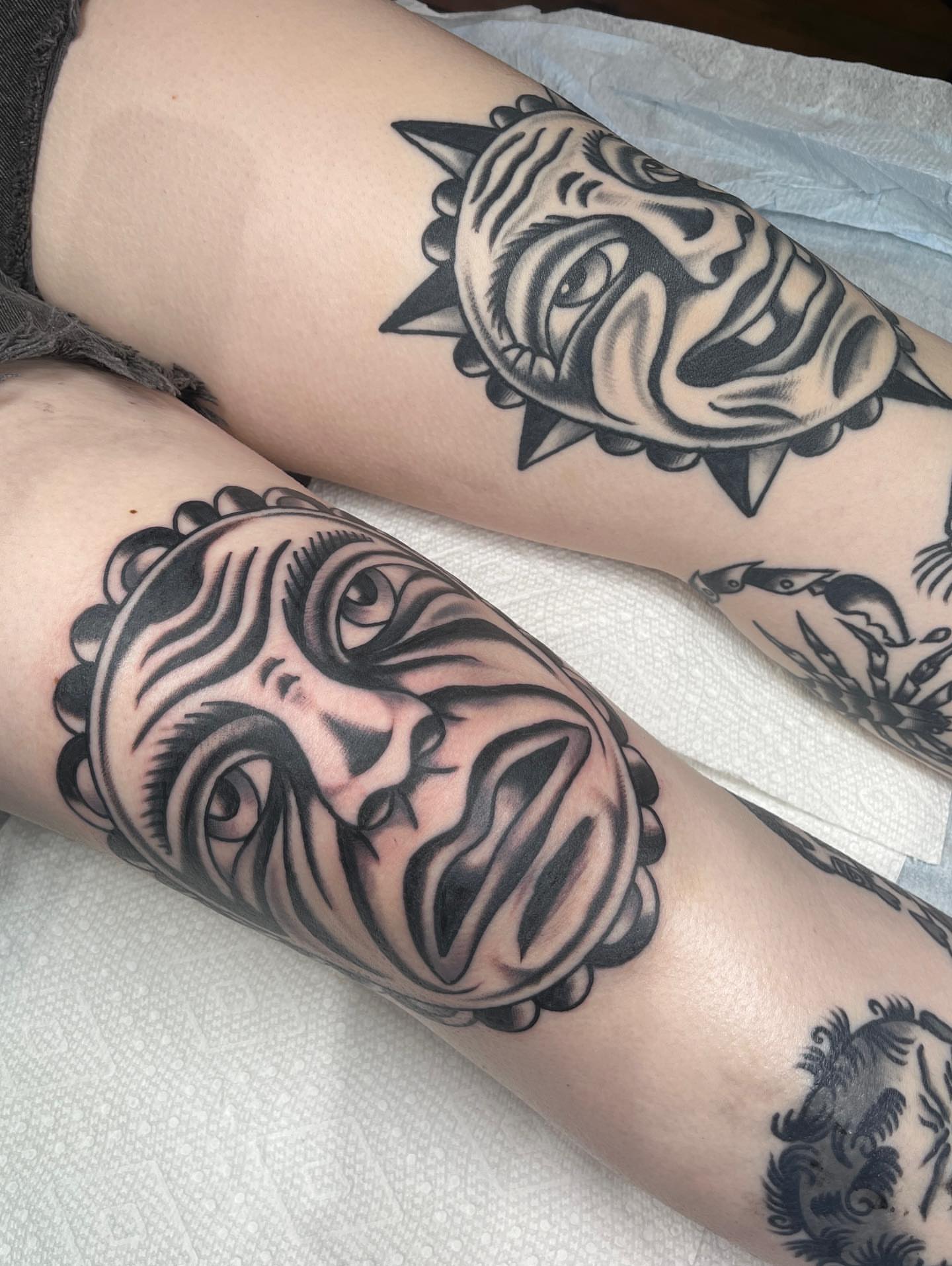 Mask black and grey tattoo on the forearm by Charlie Ostrom, Durham, North Carolina