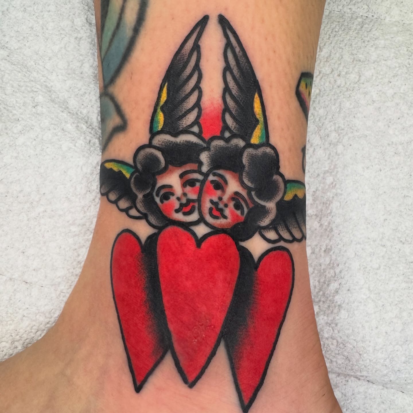 Angels with hearts American traditional tattoo on the forearm by Kenny Kastro