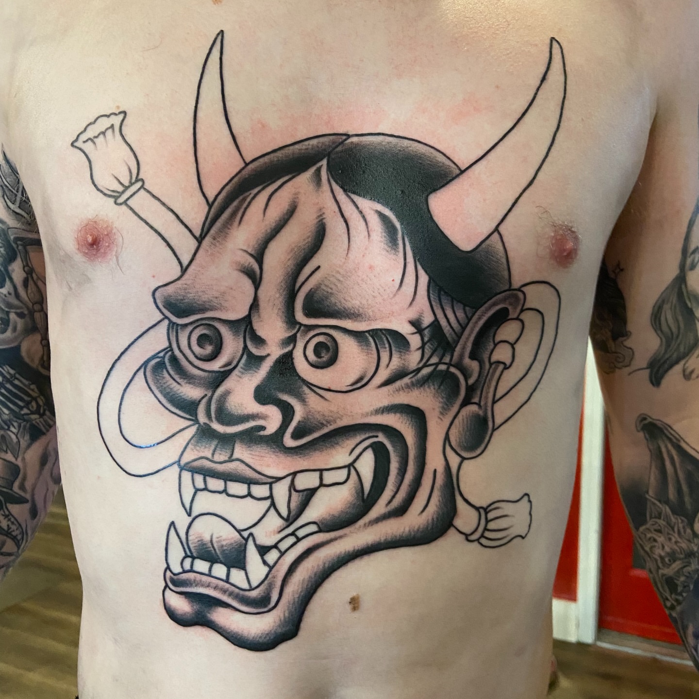 Demon mask American traditional tattoo on the chest by Anthony Robles