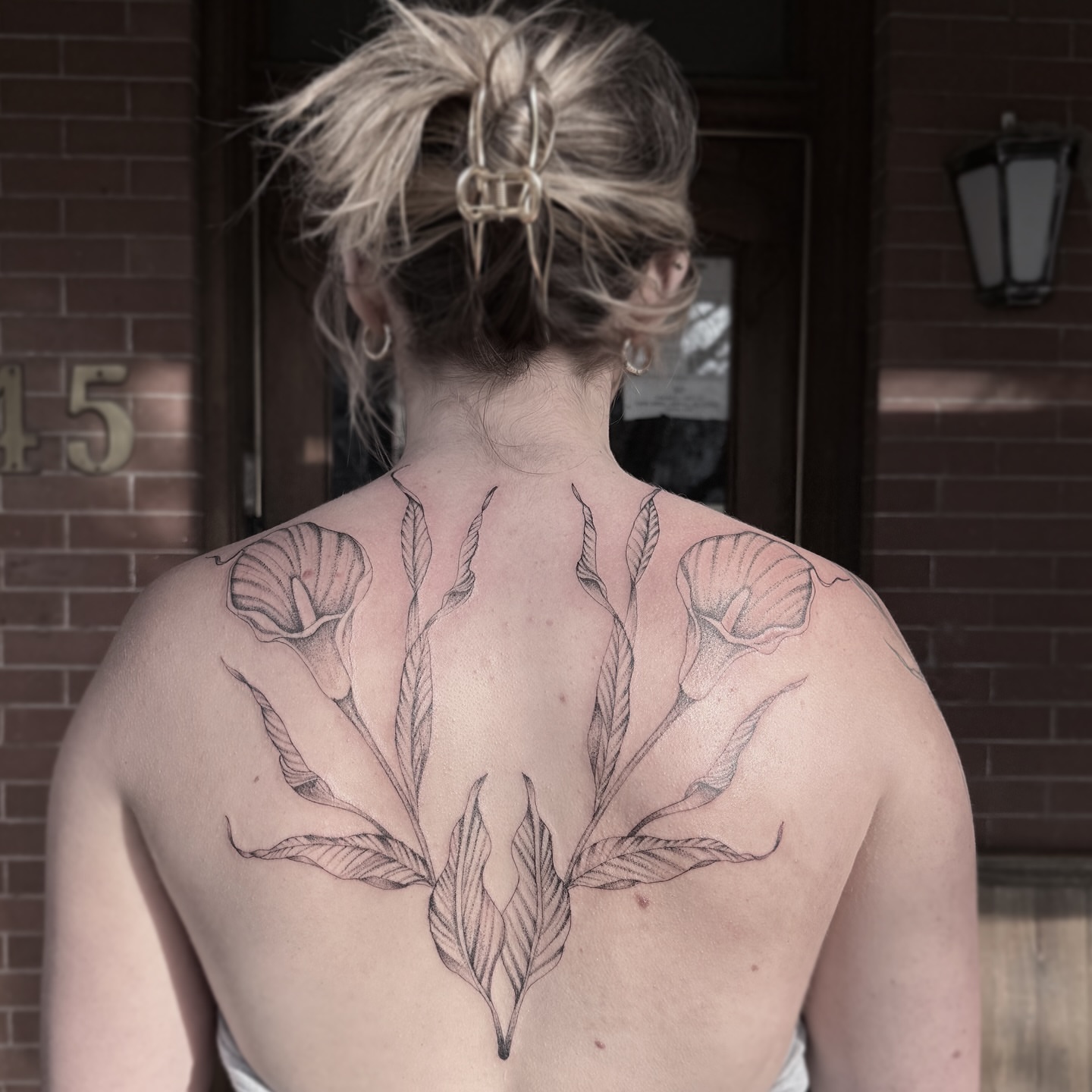 Calla lilies black and grey tattoo on the back by Rafael Alfredo Armas Hoyos, Salt Lake City, Utah