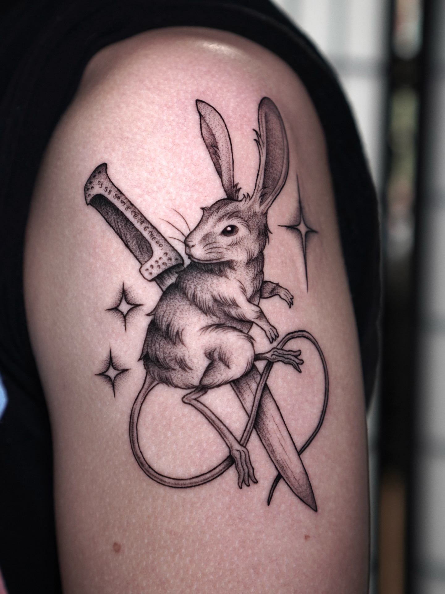 Rabbit with knife realism tattoo on the shoulder by Carlos Abad