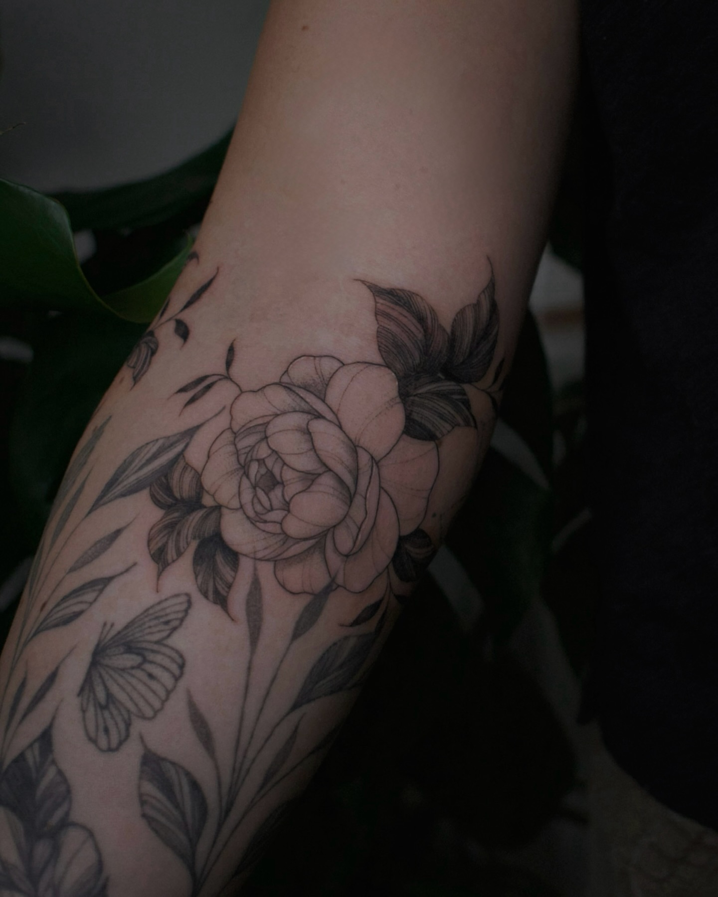 Flower black and grey tattoo on the forearm by Haley Sayers