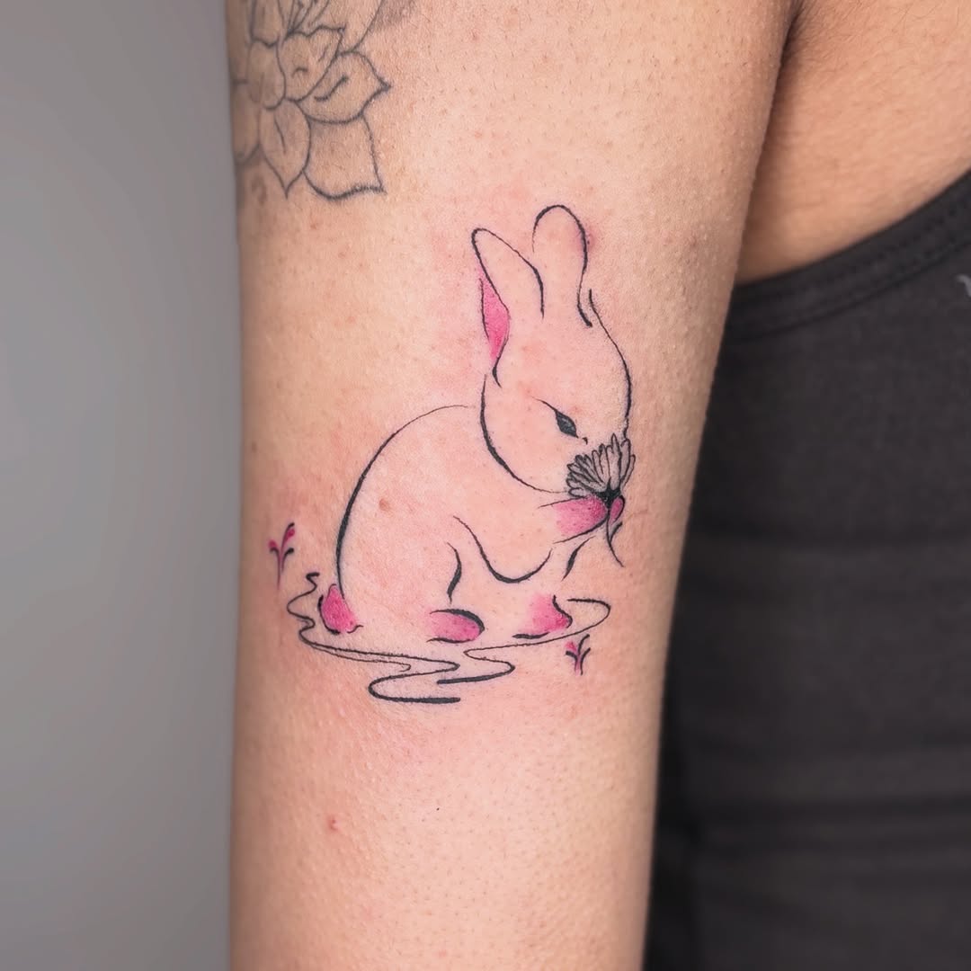 Bunny with flower fine line tattoo on the forearm by *:・kelly✧*:・゚