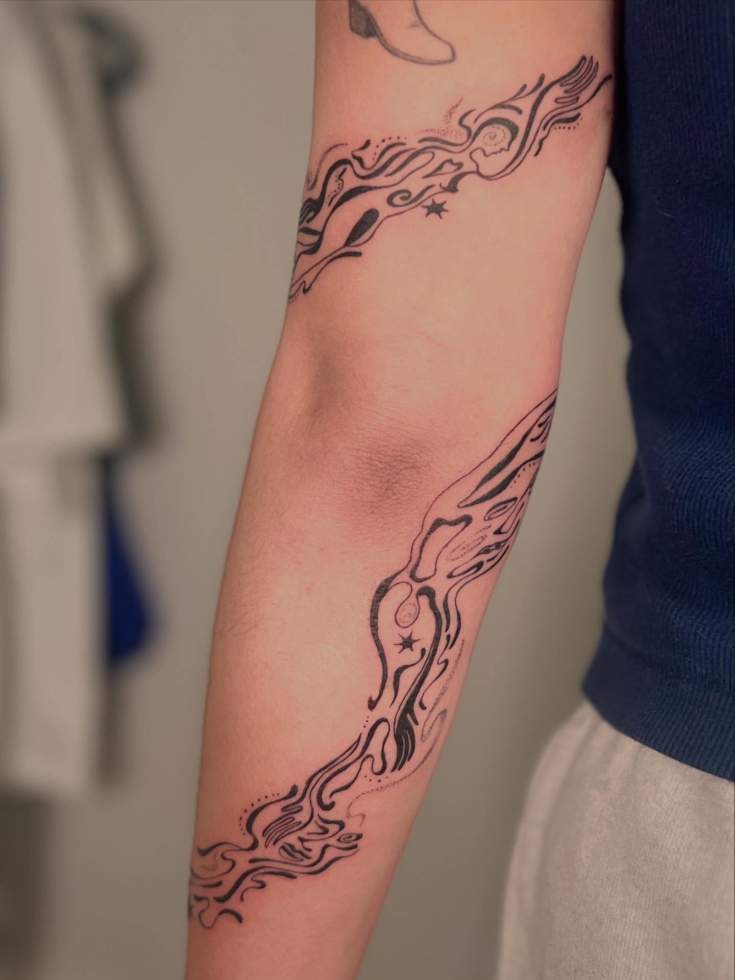 Flame black and grey tattoo on the forearm by Alex