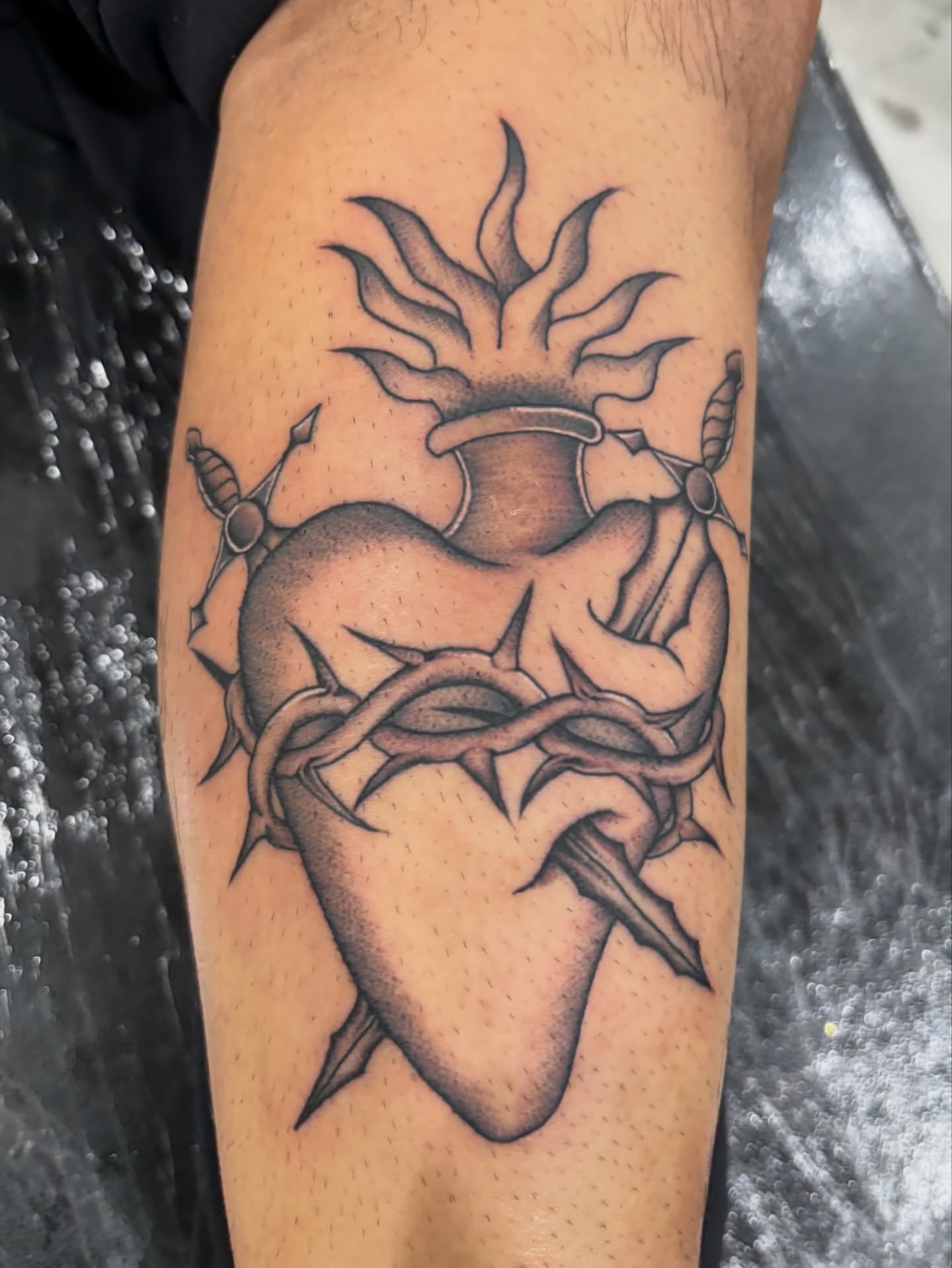 Heart with crown of thorns black and grey tattoo on the forearm by Miklo Montoya