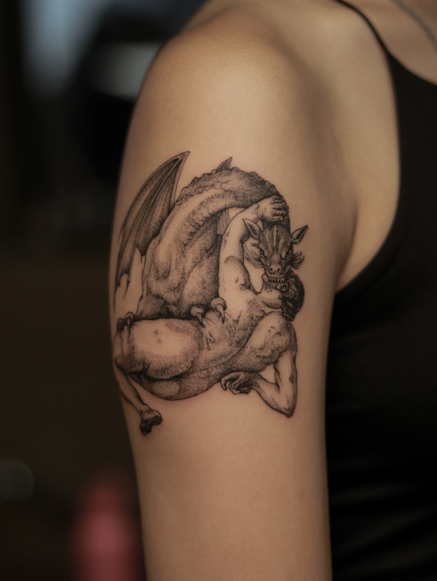 Dragon and woman dotwork tattoo on the upper arm by Arthur Kossoski