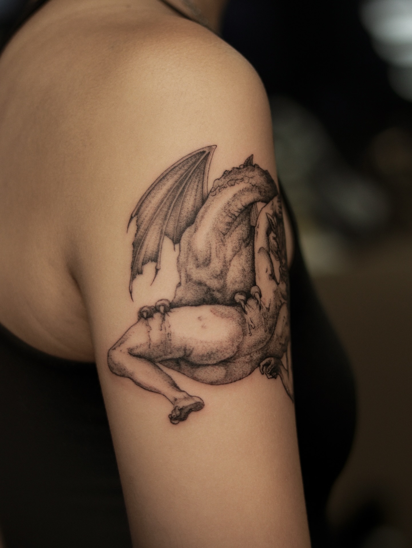 Dragon and man realism tattoo on the upper arm by Arthur Kossoski