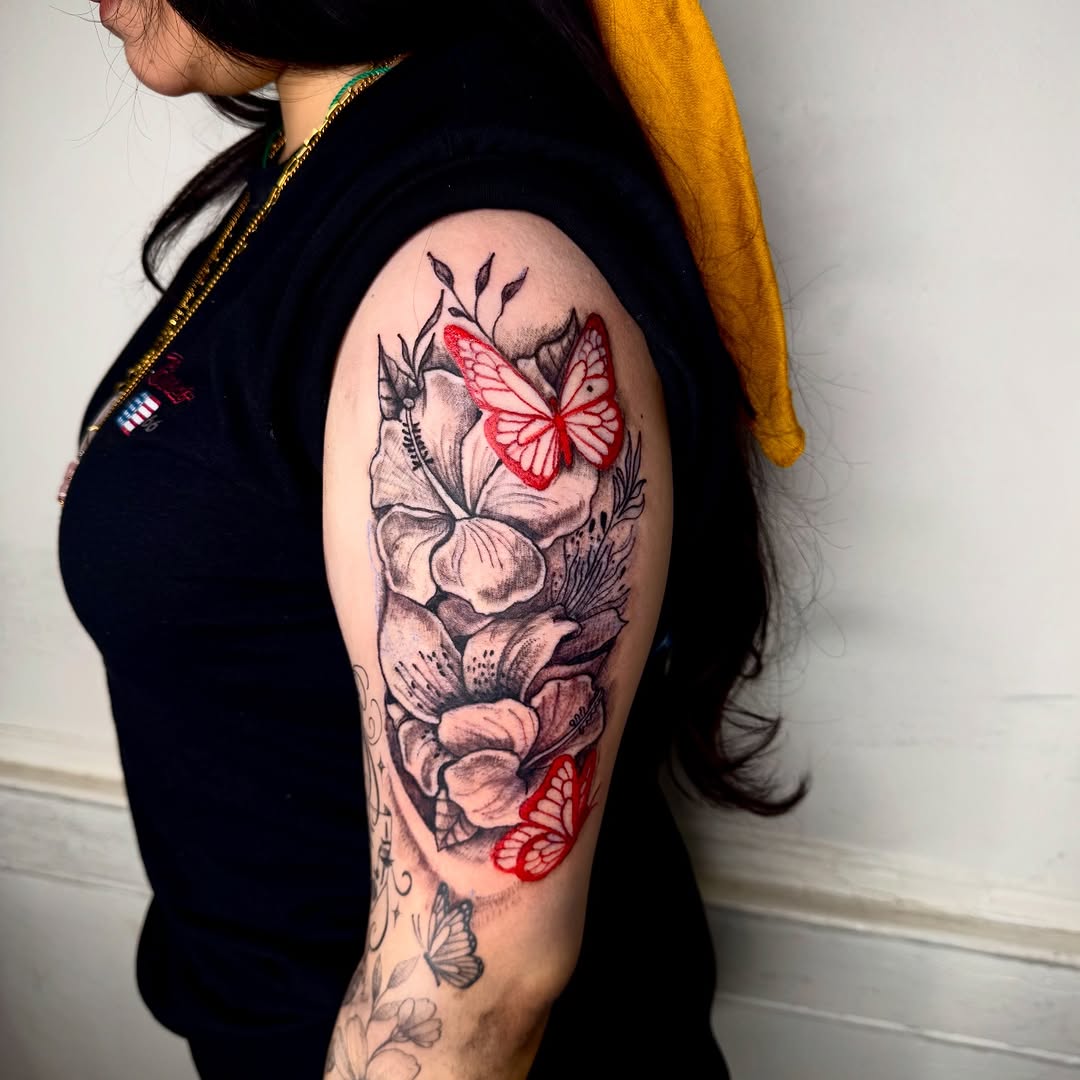 Flowers and butterflies fine line tattoo on the upper arm by JayyeSosa