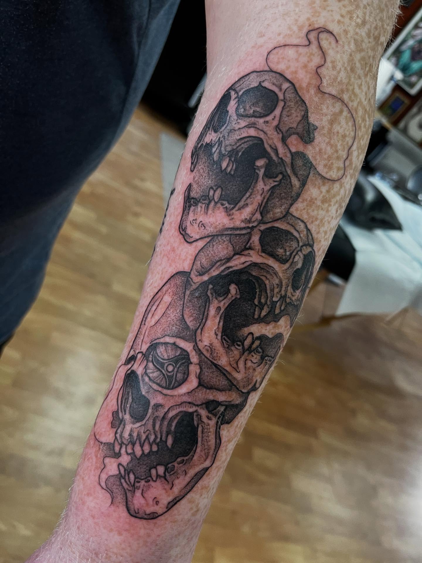 Skulls black and grey tattoo on the forearm by Taya Lynn, Hudson, Wisconsin